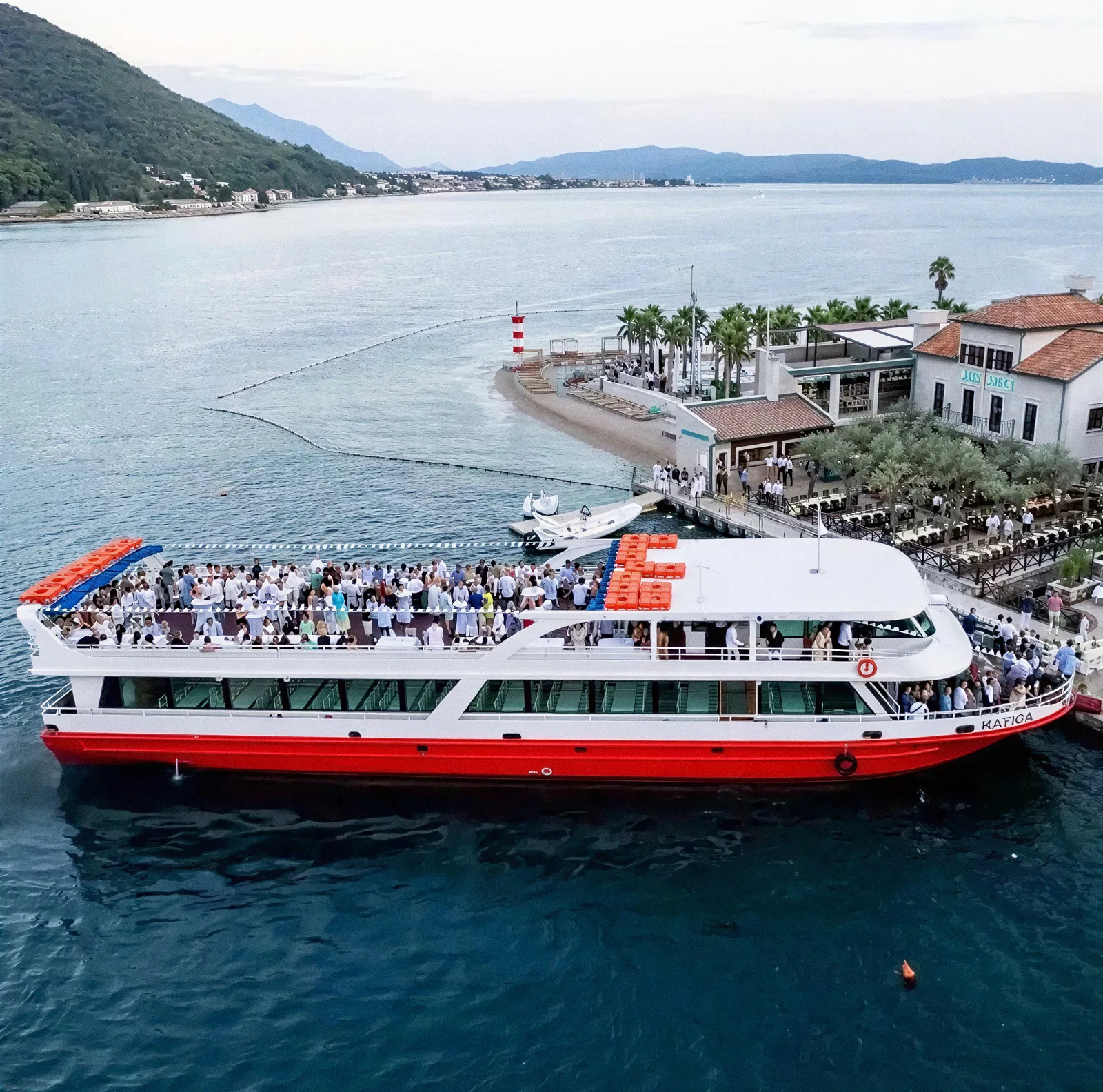Katica, a two deck excursion boat, alongside at Tivat in the evening with both decks full of guests