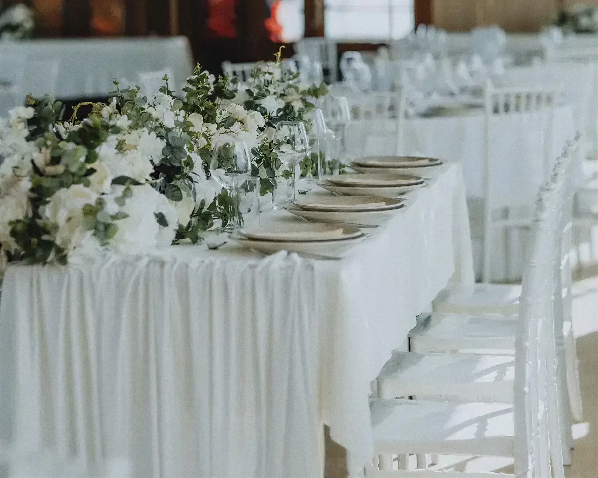 A wedding table aboard Katica dressed in white linen with eucalyptus and roses